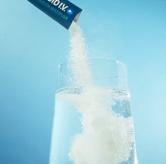 Image of a stick of Liquid I.V.® being poured into a glass. 