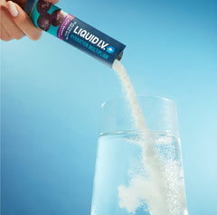 Image of a stick of Liquid I.V.® being poured into a glass. 