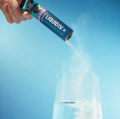 Image of a stick of Liquid I.V.® being poured into a glass. 