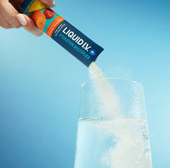 Image of a stick of Liquid I.V.® being poured into a glass. 