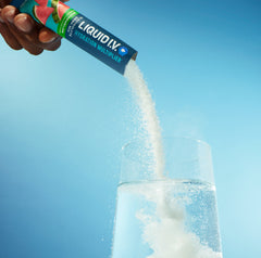 Image of a stick of Liquid I.V.® being poured into a glass. 